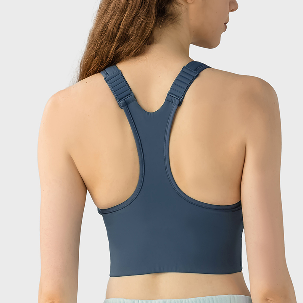 Blue sports bra worn by a person on a light gray background